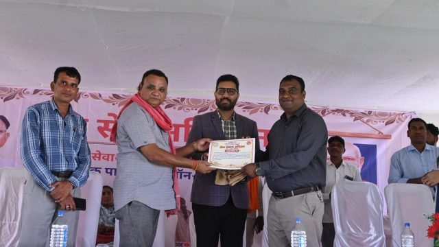 कोसरंगी में आयोजित सेवा सेतु शिविर के दौरान मंच पर प्रमाण पत्र लेते हुए व्यक्ति।